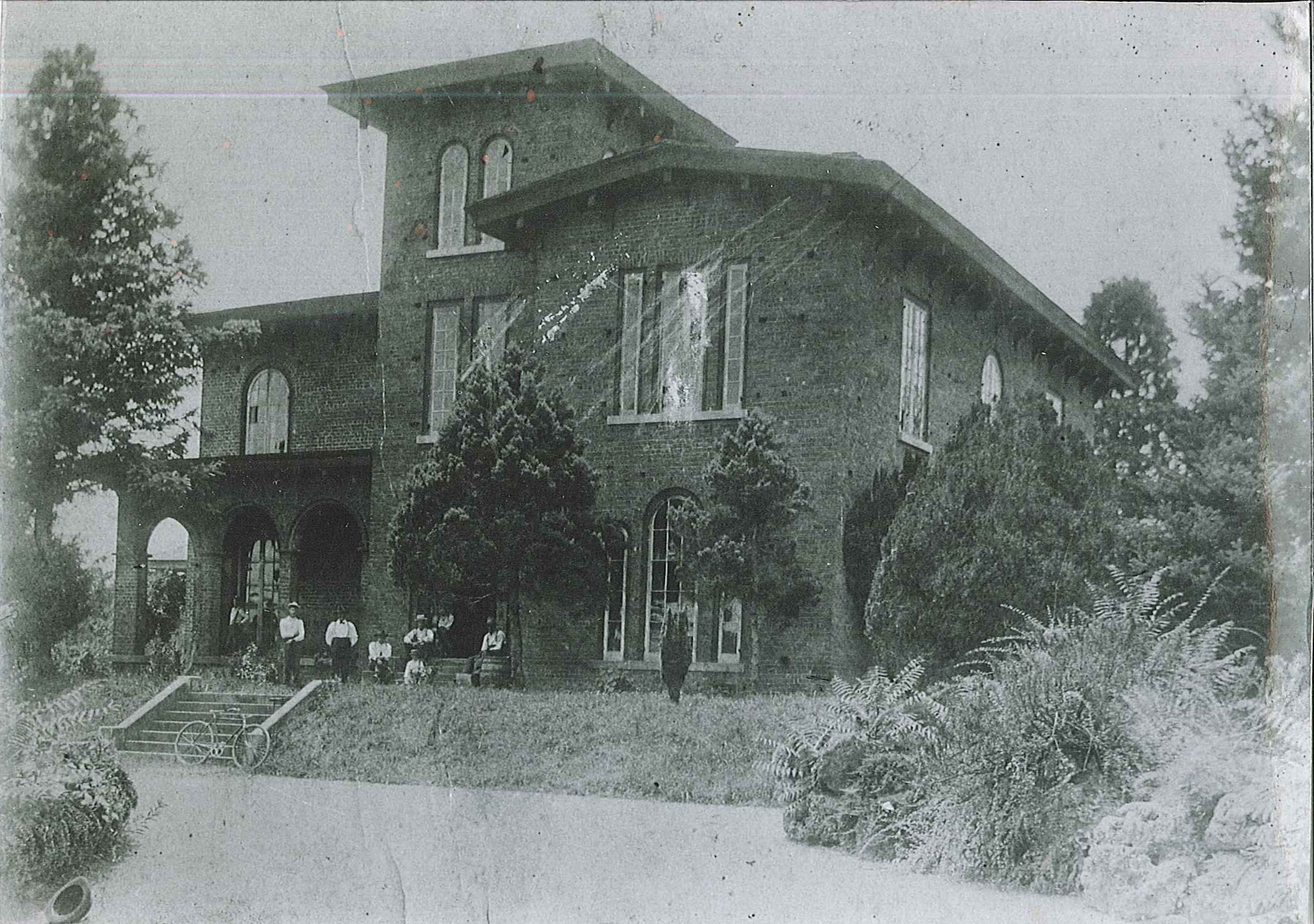 A black and white old image of the Manor House at Barnsley Resort.