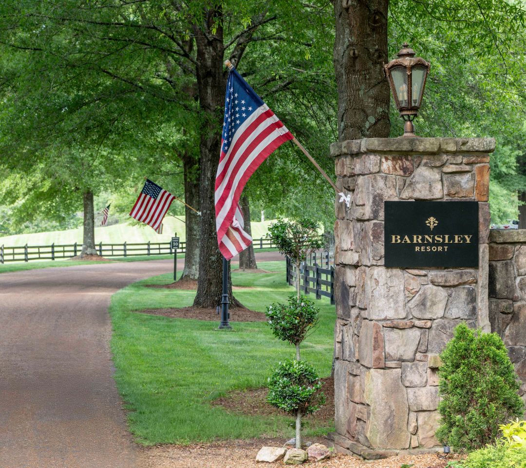 a road lined with trees and flags