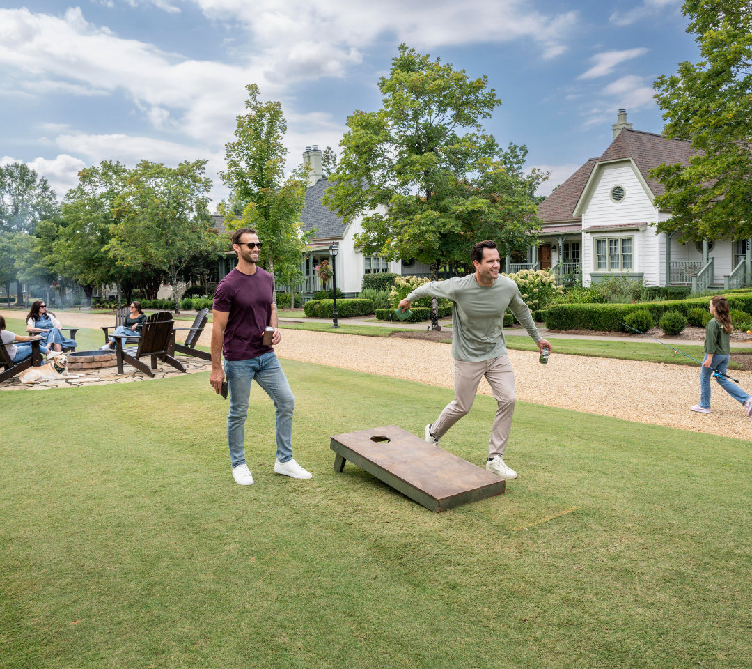 Two men playing cornhole