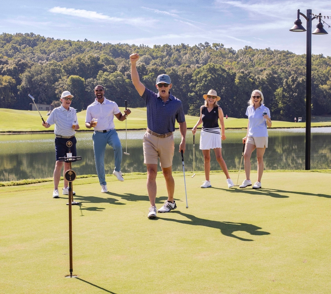 a groups of adults cheering on a golf course