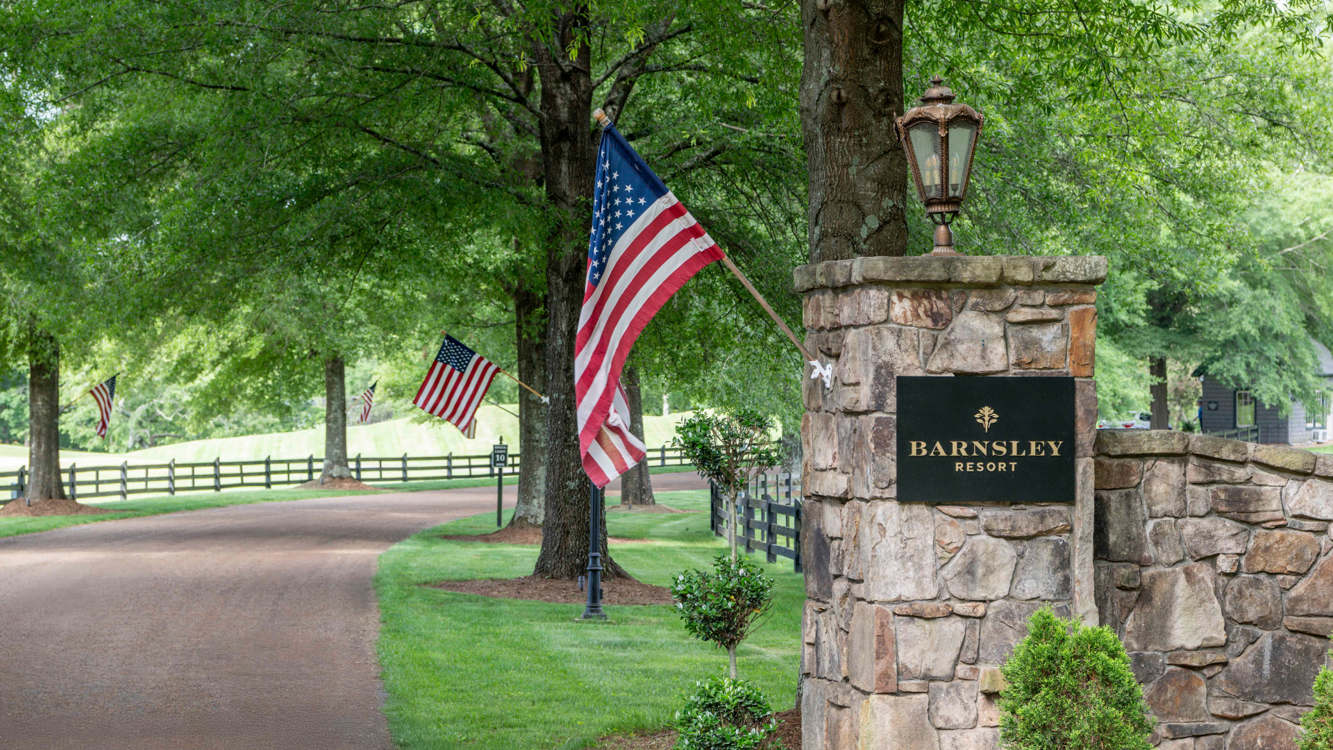 a road lined with trees and flags