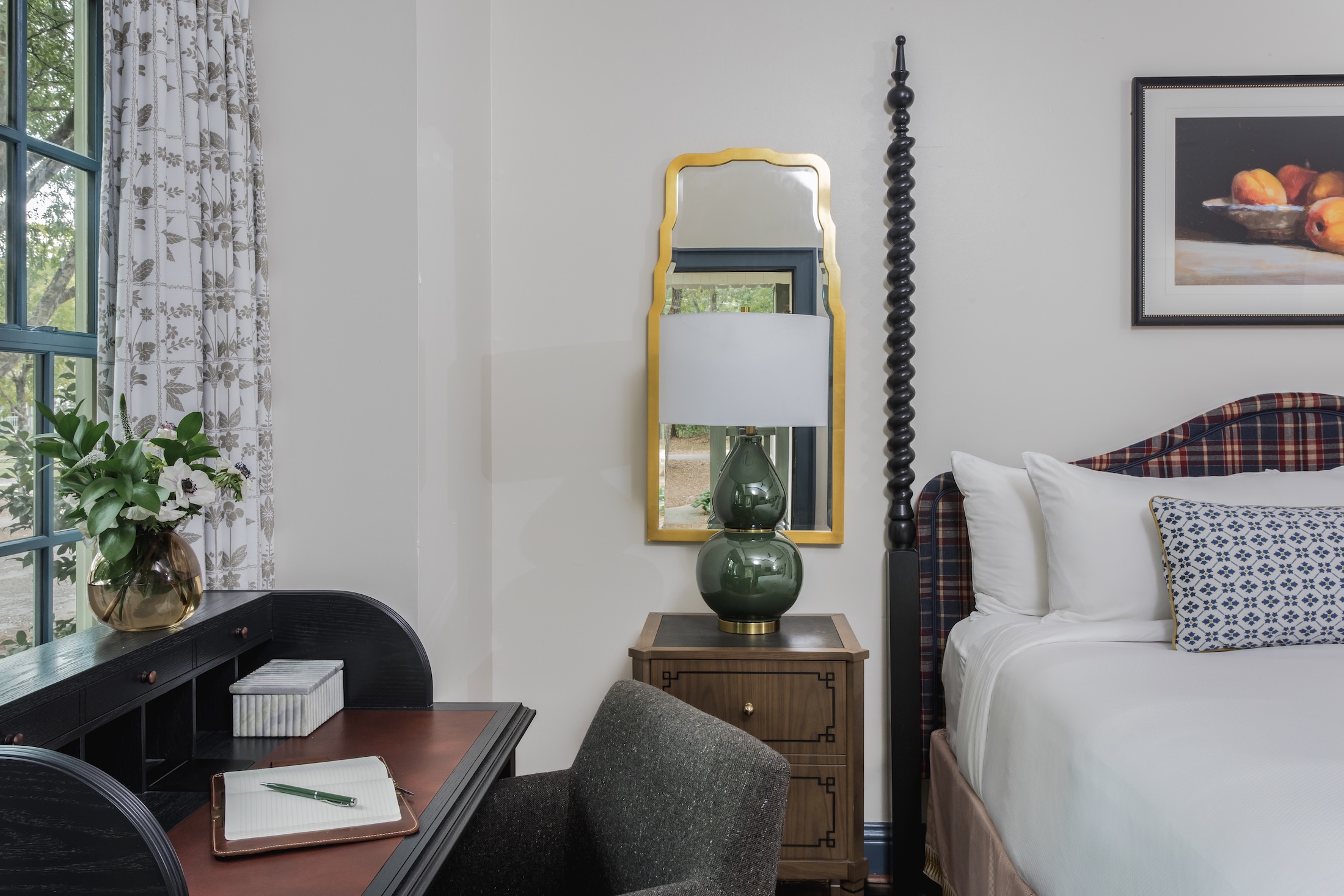 A desk and chair next to a bed.