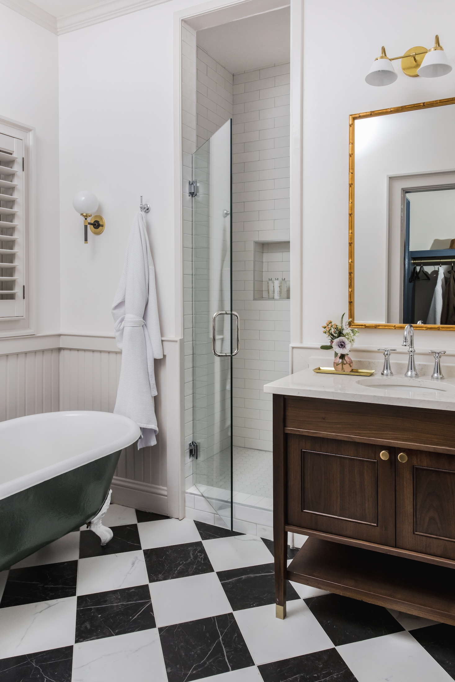 The clawfoot tub, stand up shower and sink in the bathroom of Manor Cottages at Barnsley Resort.