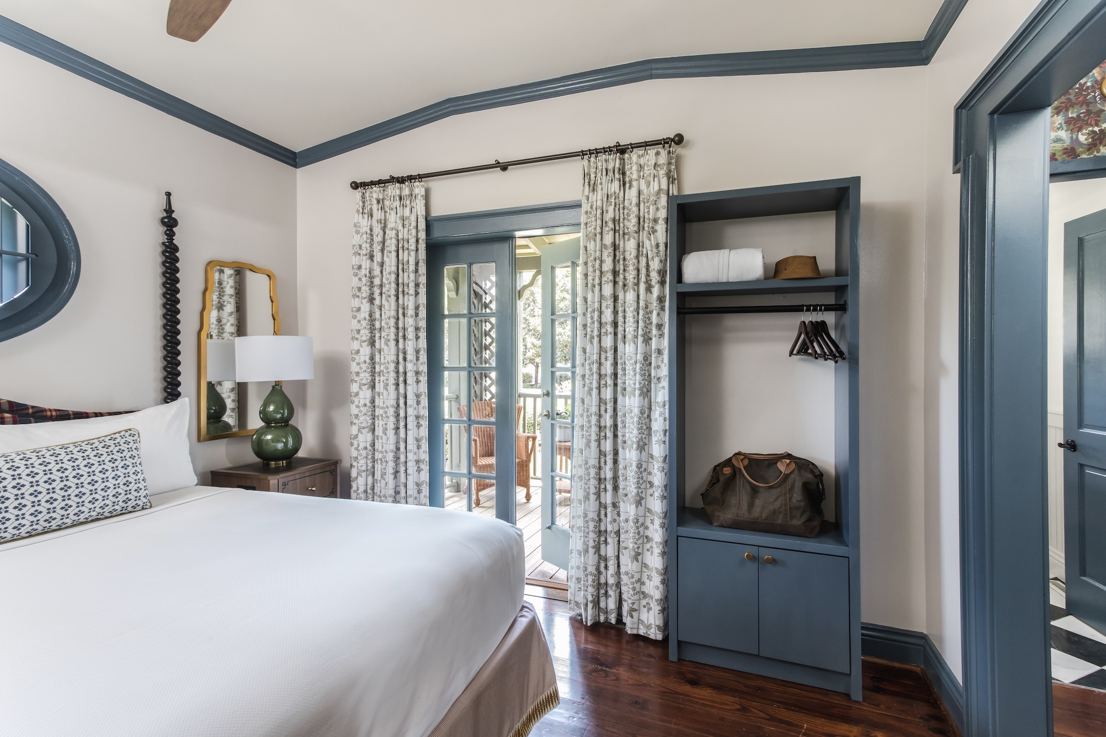 The bedroom with closet area and door to furnished terrace in the Cottage Suites at Barnsley Resort.