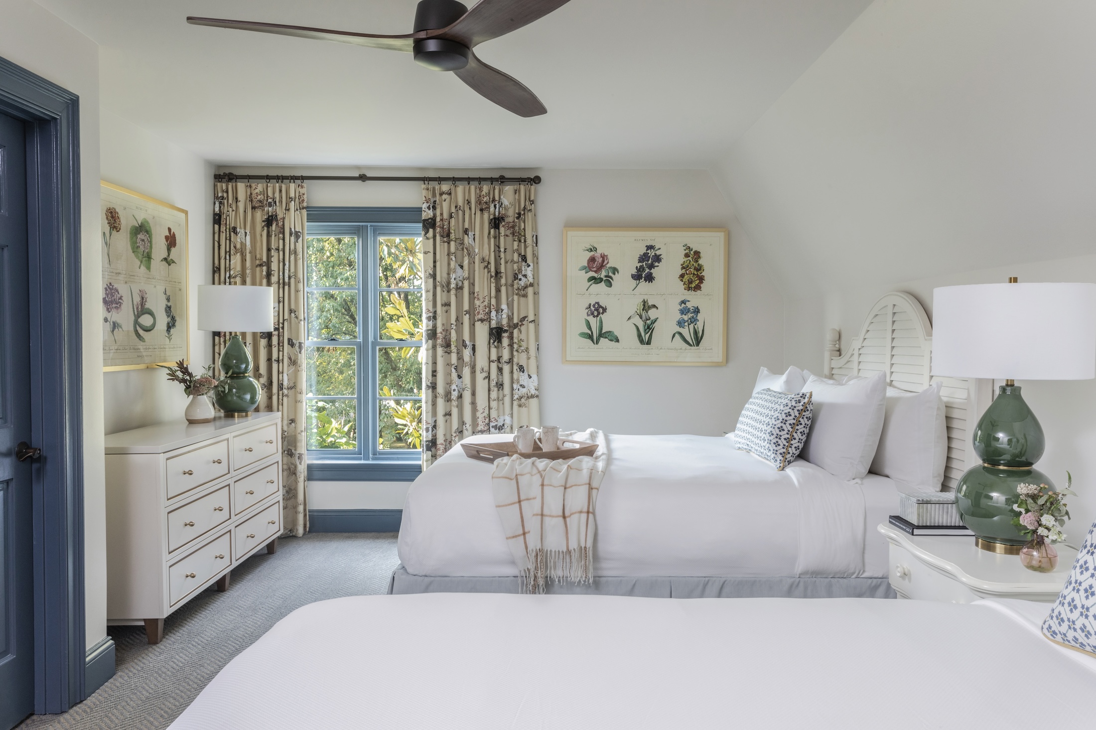 Two bed room with dresser and window view in the Julia Cottage at Barnsley Resort.
