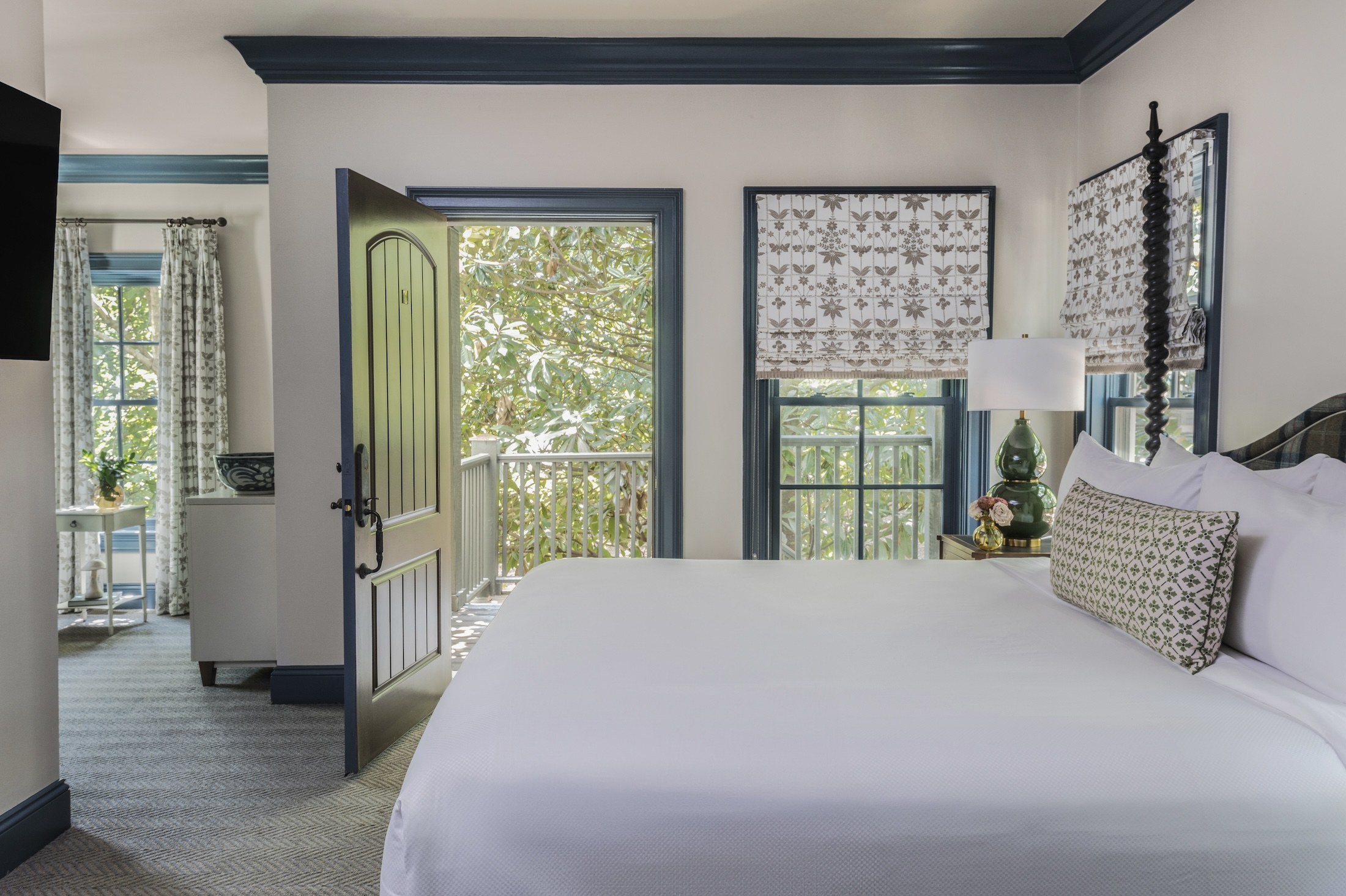 A king bedroom with door open to the terrace in the Julia Cottage at Barnsley Resort.