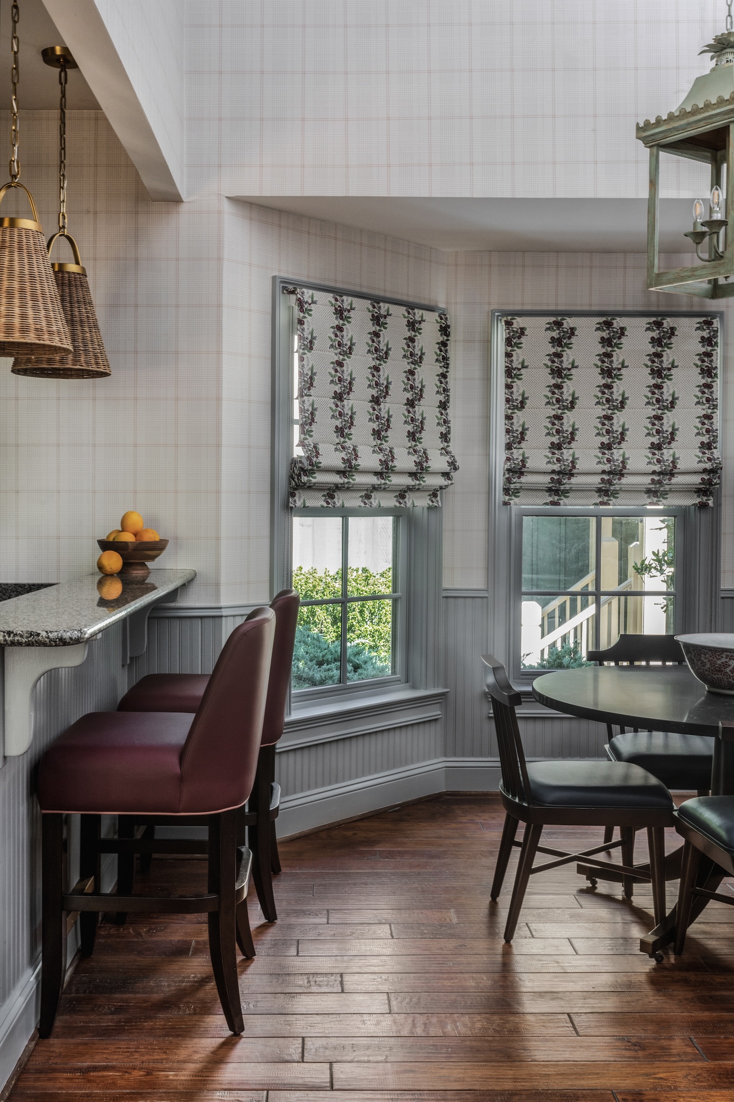 The dining area in a bay window of the Julia Cottage at Barnsley Resort next to two bar seats by the kitchen.