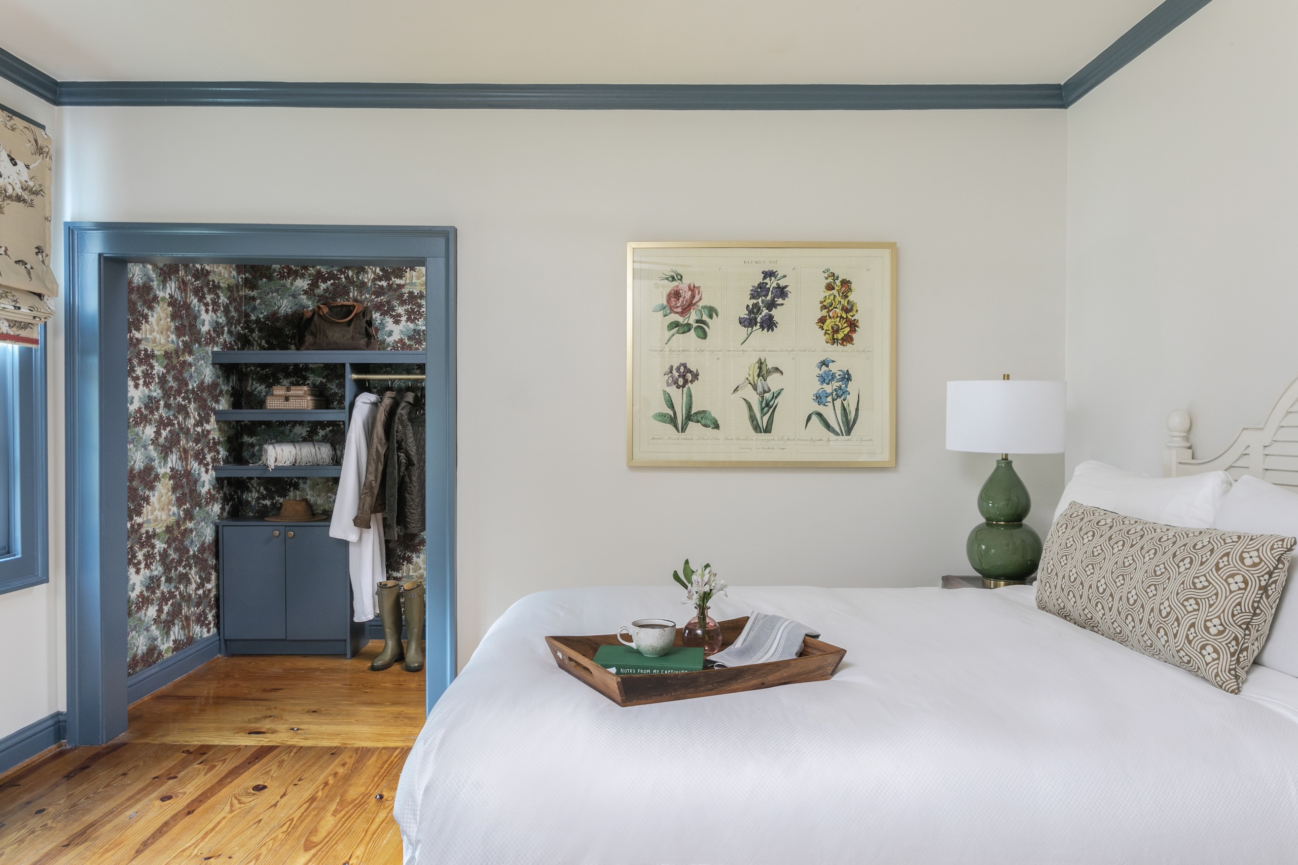 A bedroom in Wheaton Cottage. A queen bed and walk in closet.