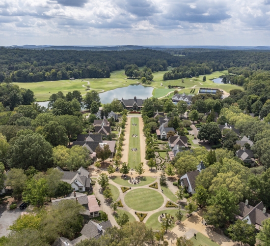 Aerial view of a resort with streets lined with one to four bedroom suites cottages.