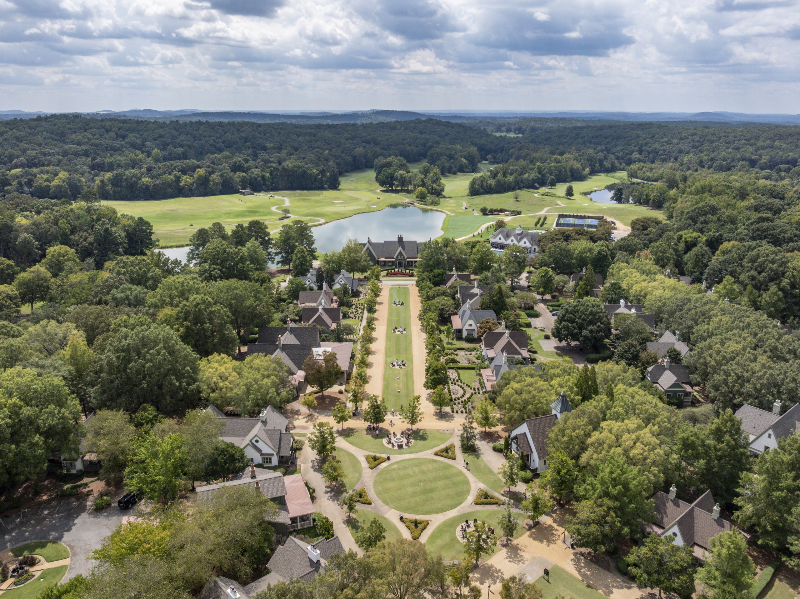 Aerial view of a resort with streets lined with one to four bedroom suites cottages.