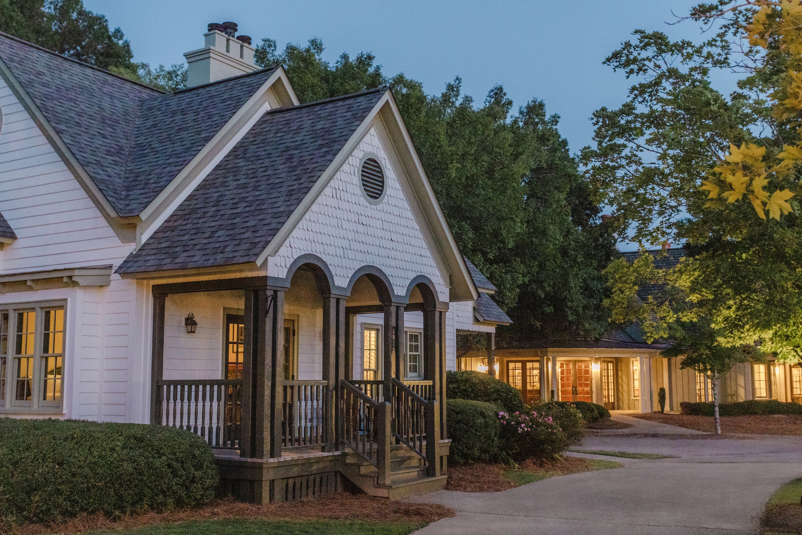 The exterior of a cottage at Barnsley Resort at dusk.