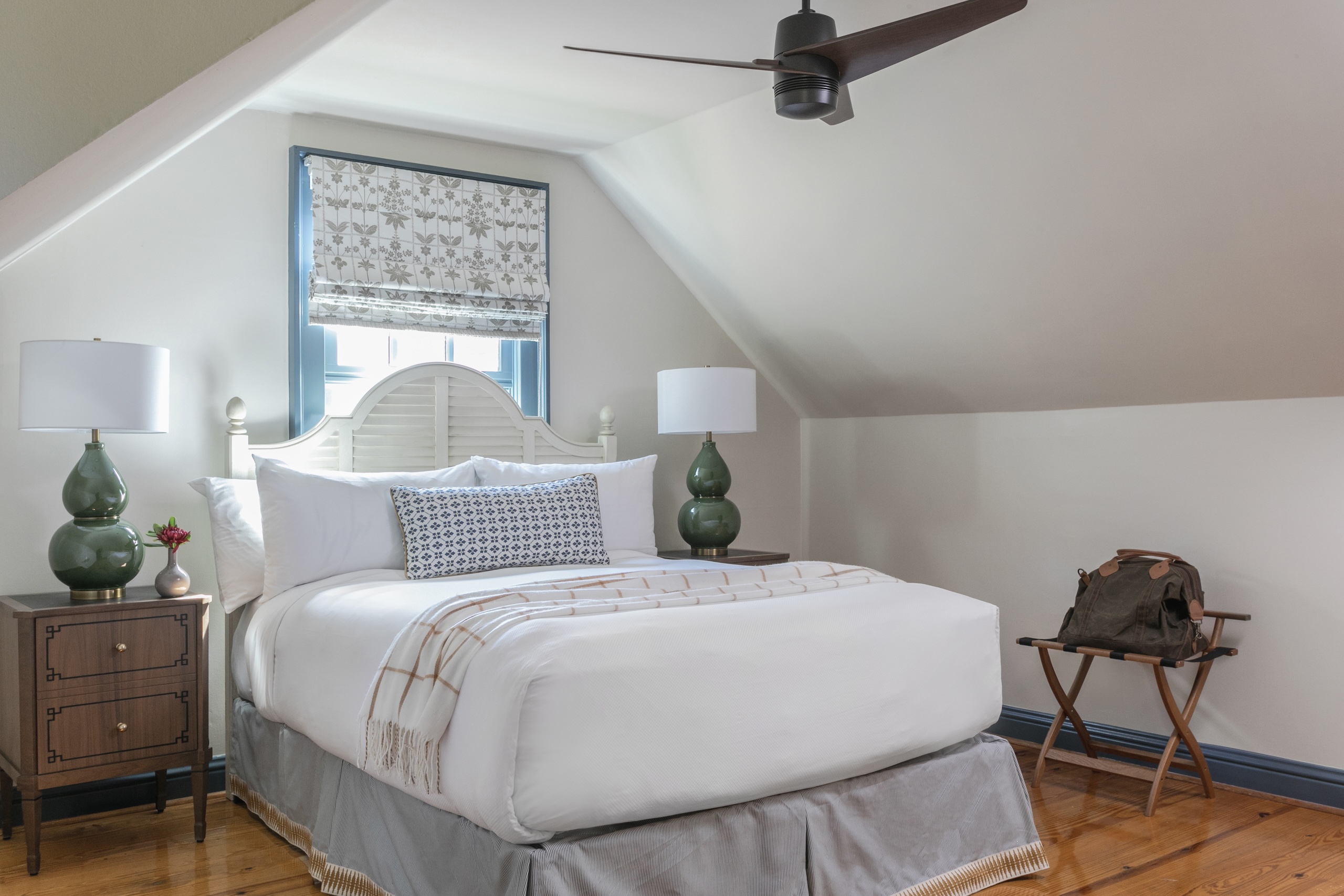A queen size bed in the upstairs bedroom of Wheaton Cottage at Barnsley Resort.