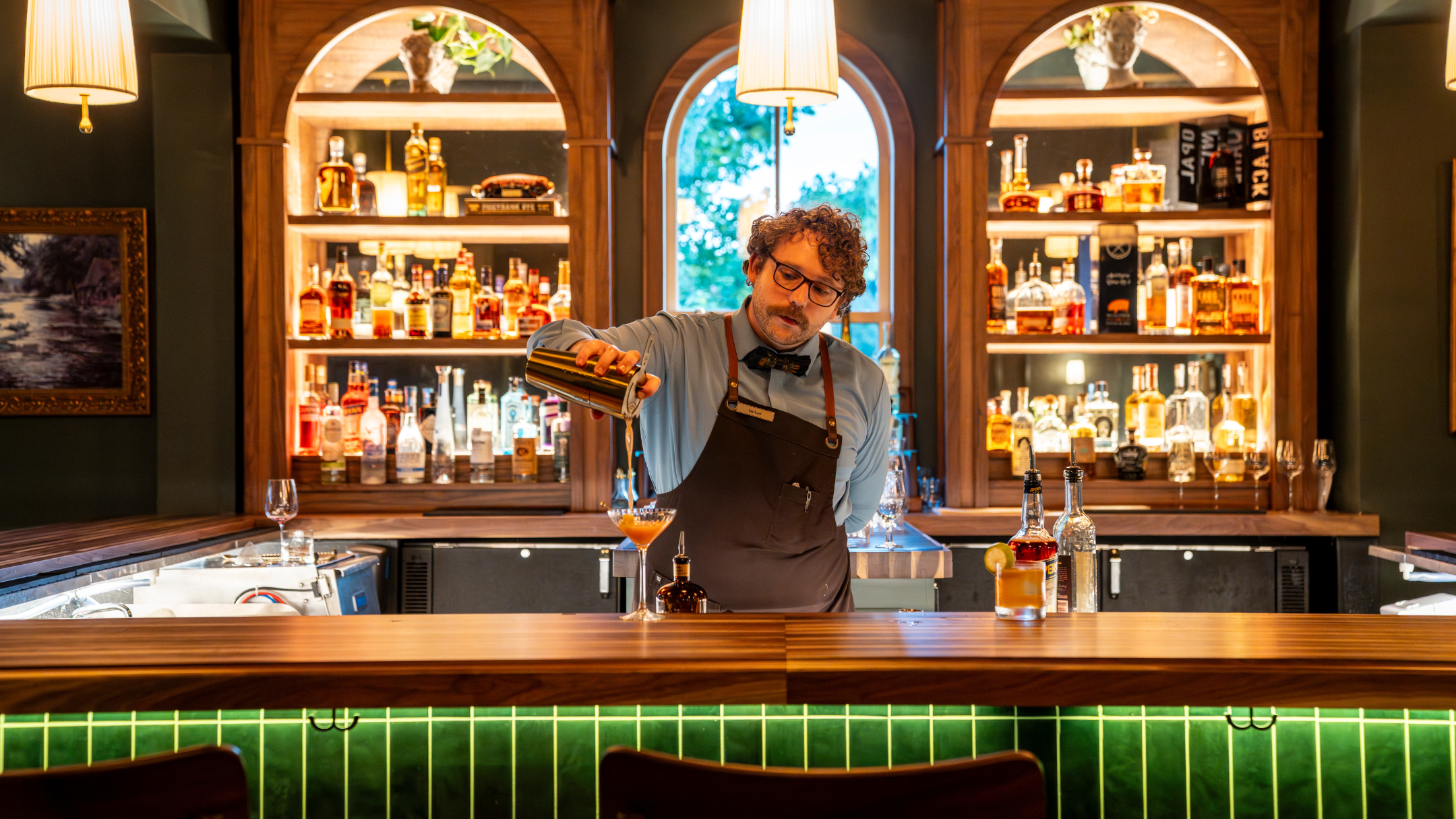 bartender crafting a cocktail at a bar