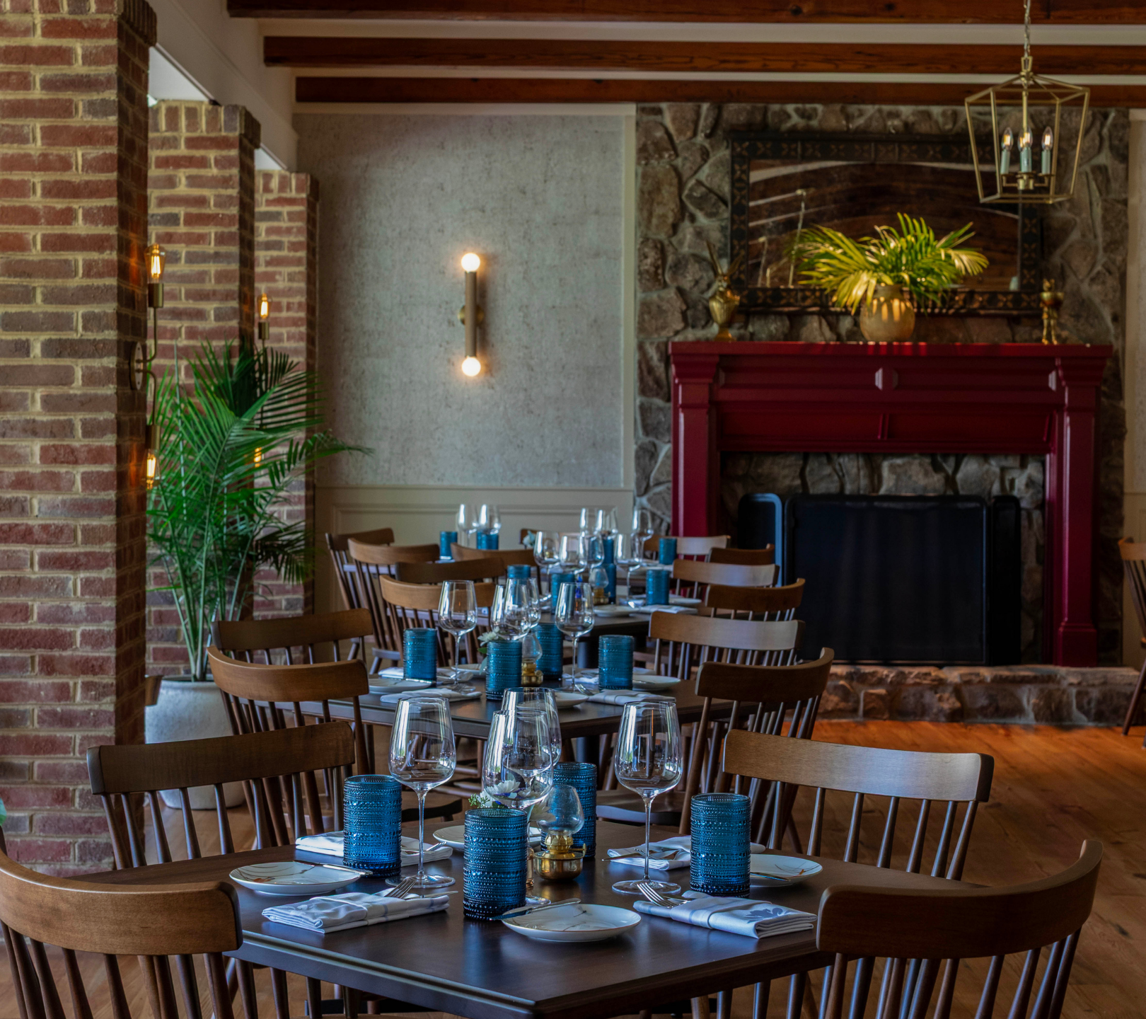 Dining room lined with brick pillars and set tables
