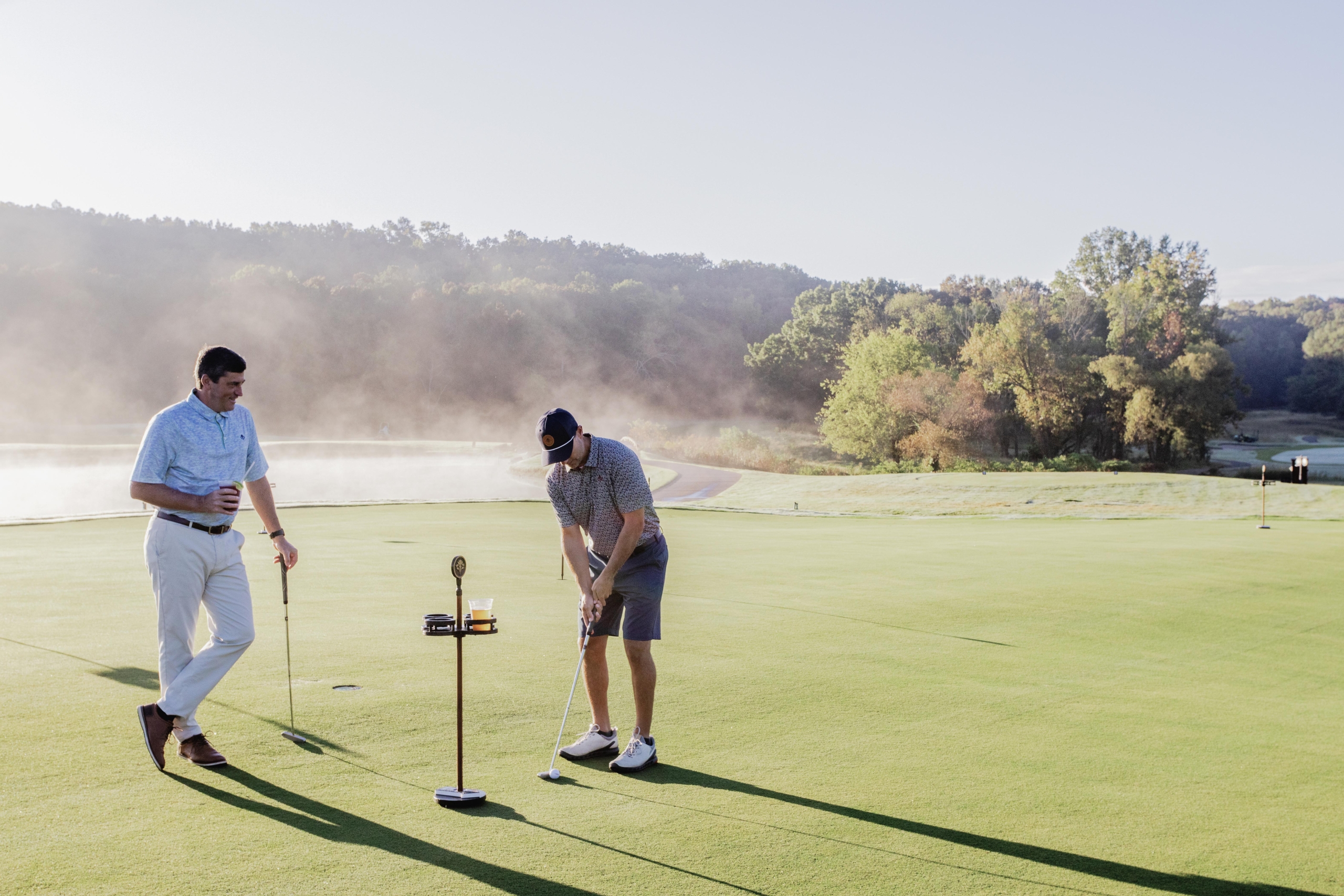 Two men on a golf putting course