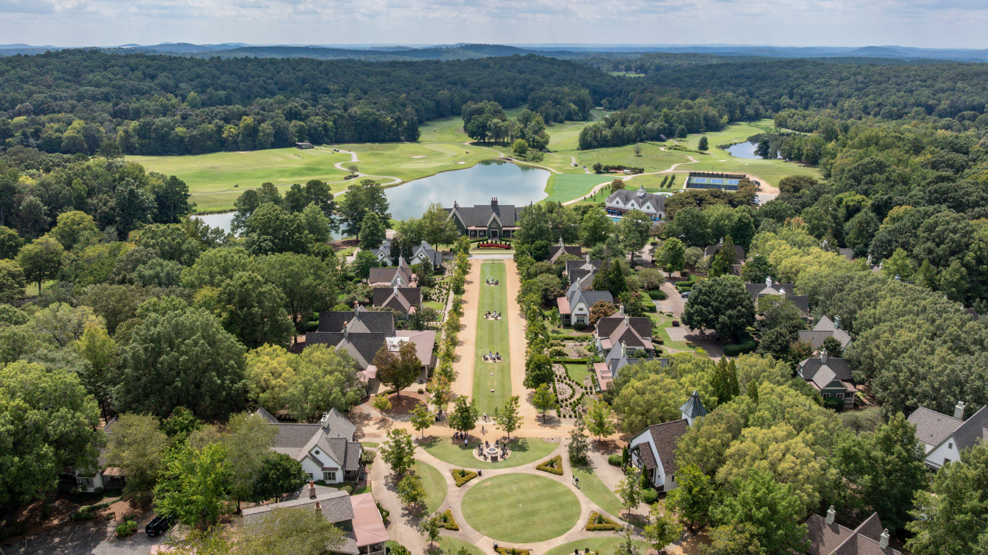 Aerial view of a resort with streets lined with one to four bedroom suites cottages.
