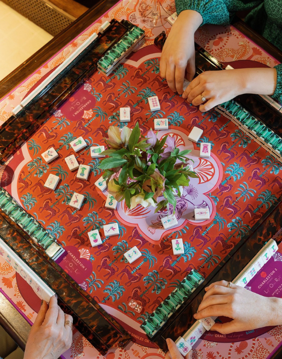 hands playing mahjong, flower centerpiece