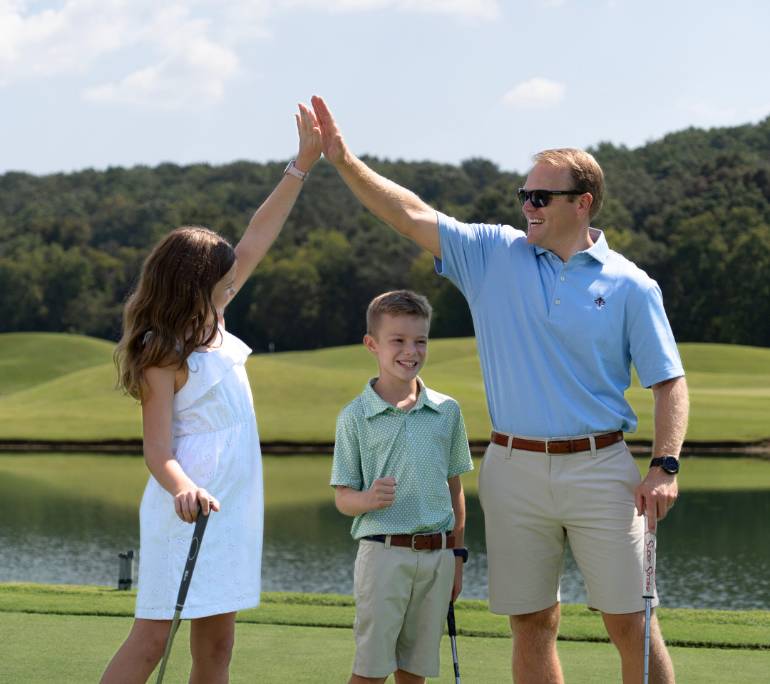 man and girl high fiving, boy happy on putting girl