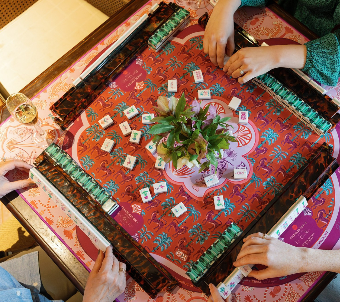 hands playing mahjong, flower centerpiece