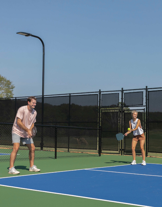 two people playing pickleball