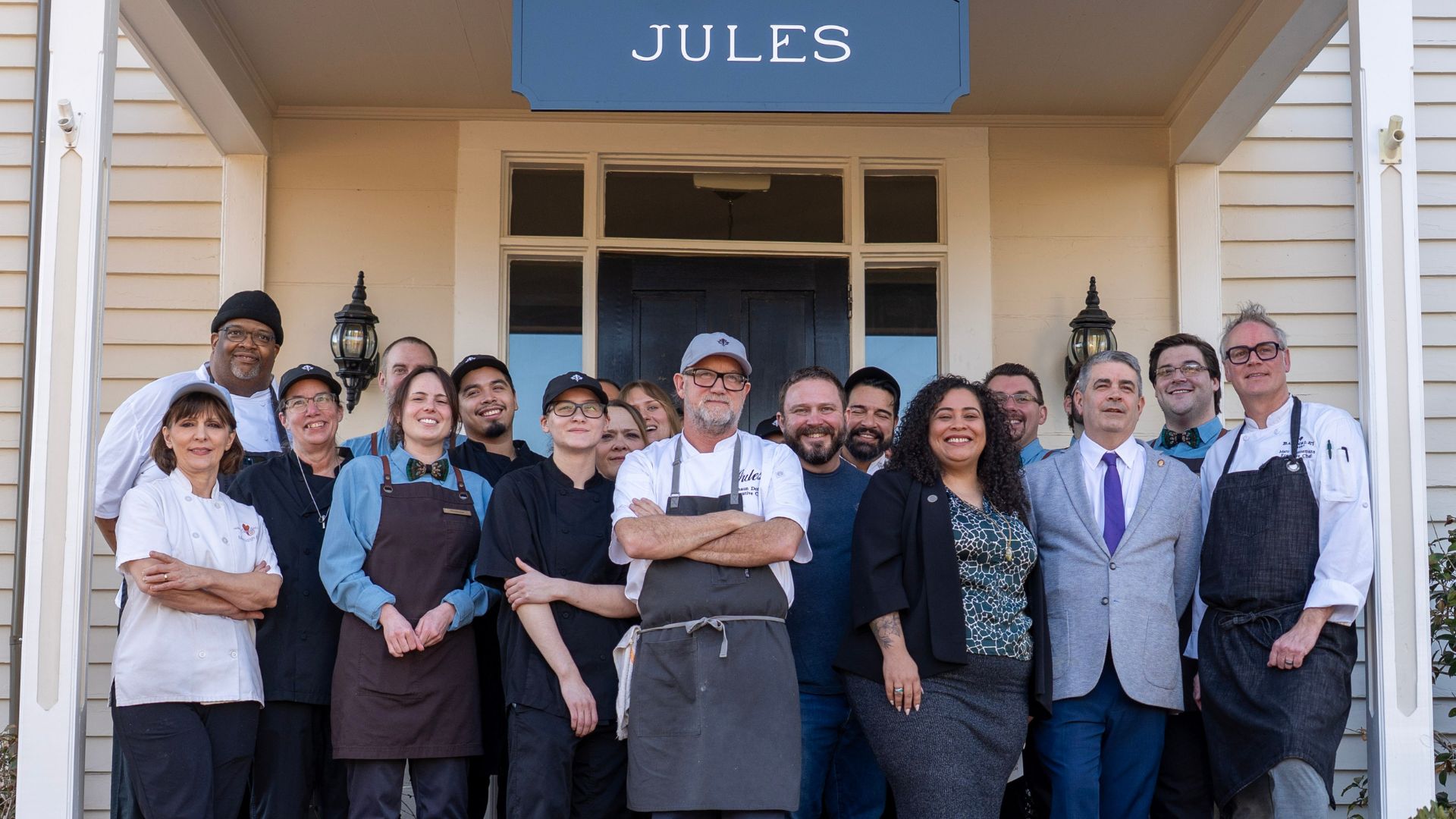 group of chefs in front of white building