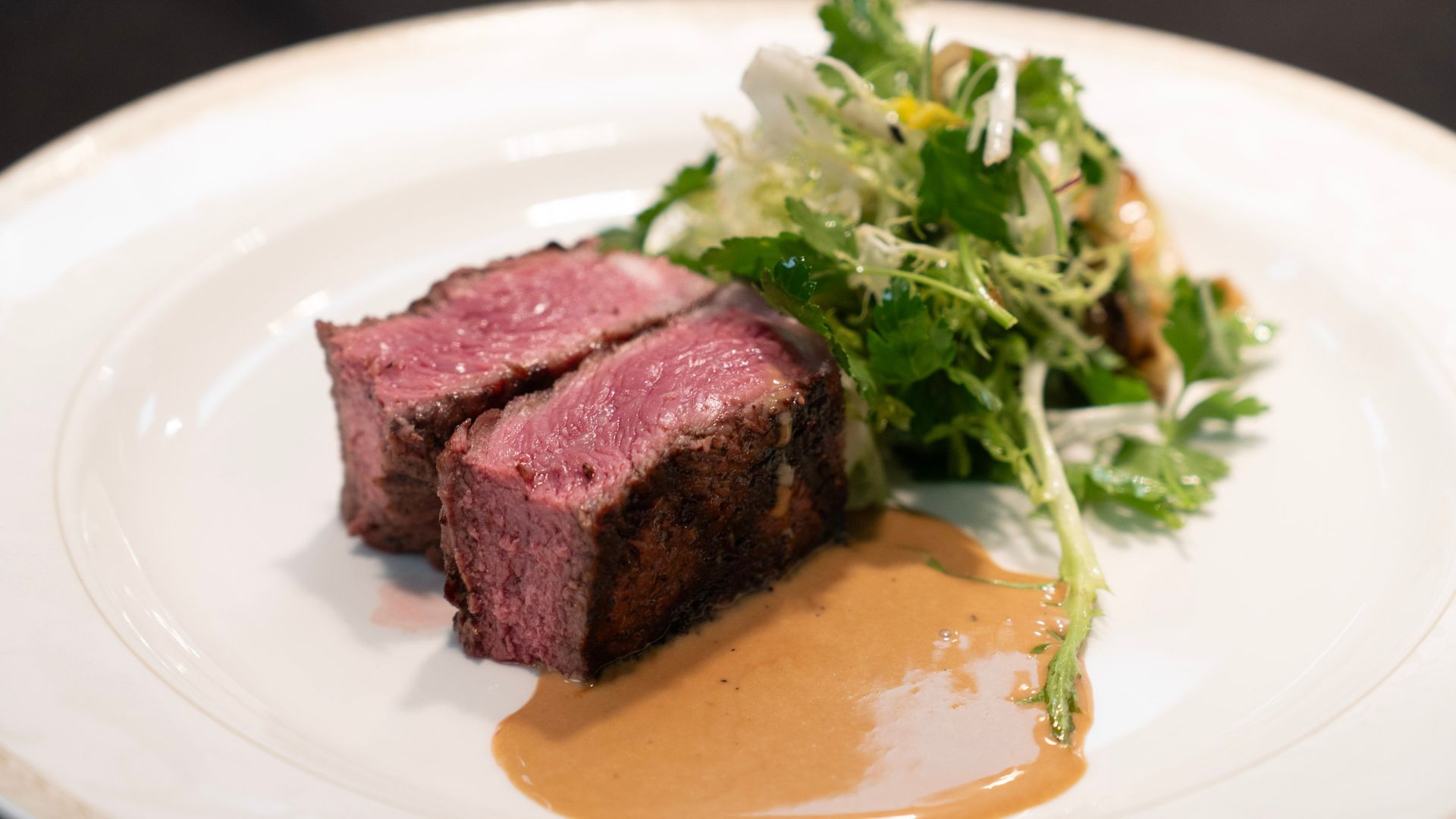 plated dish of beef with greens