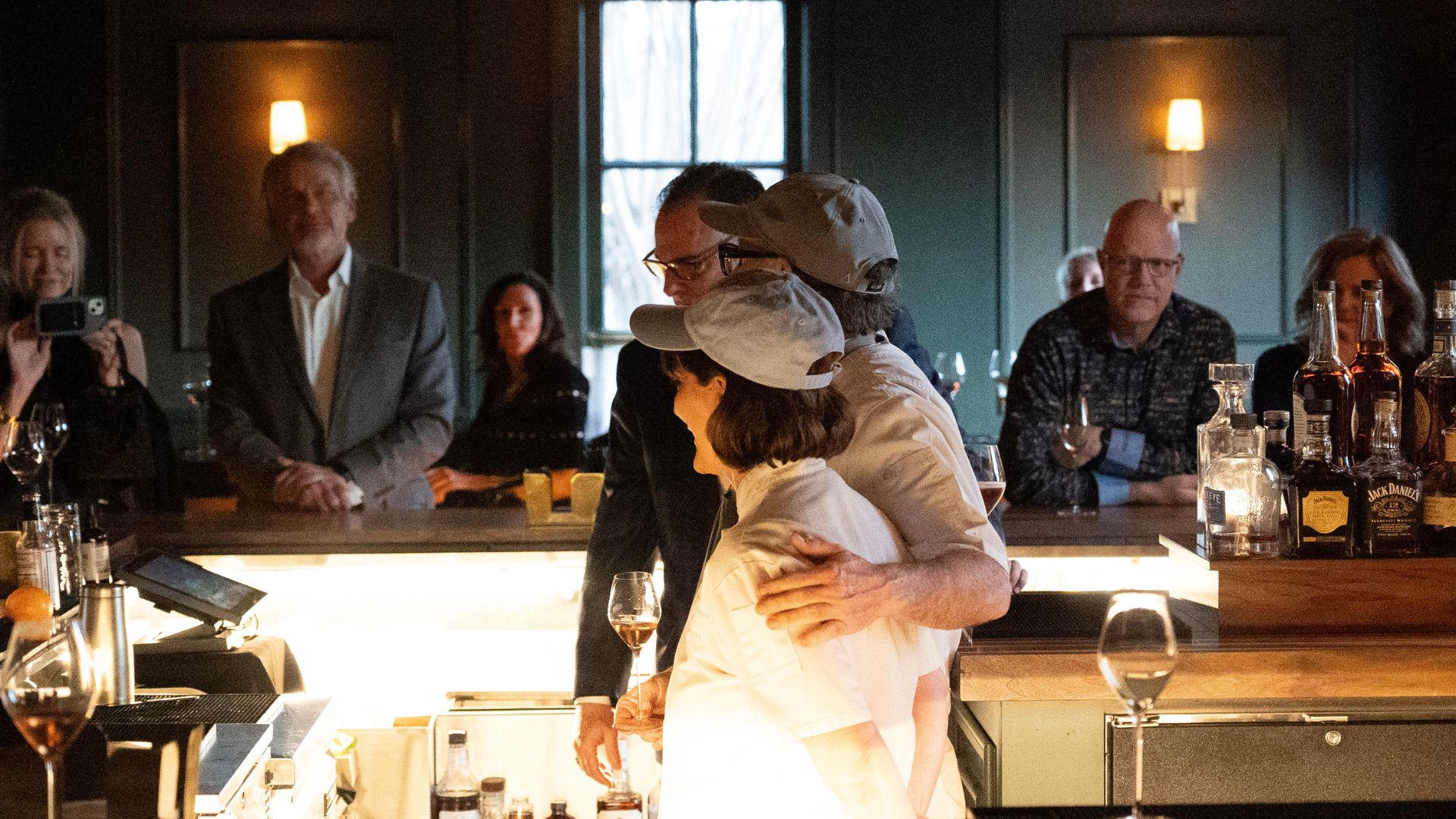 two chefs talking to group of people