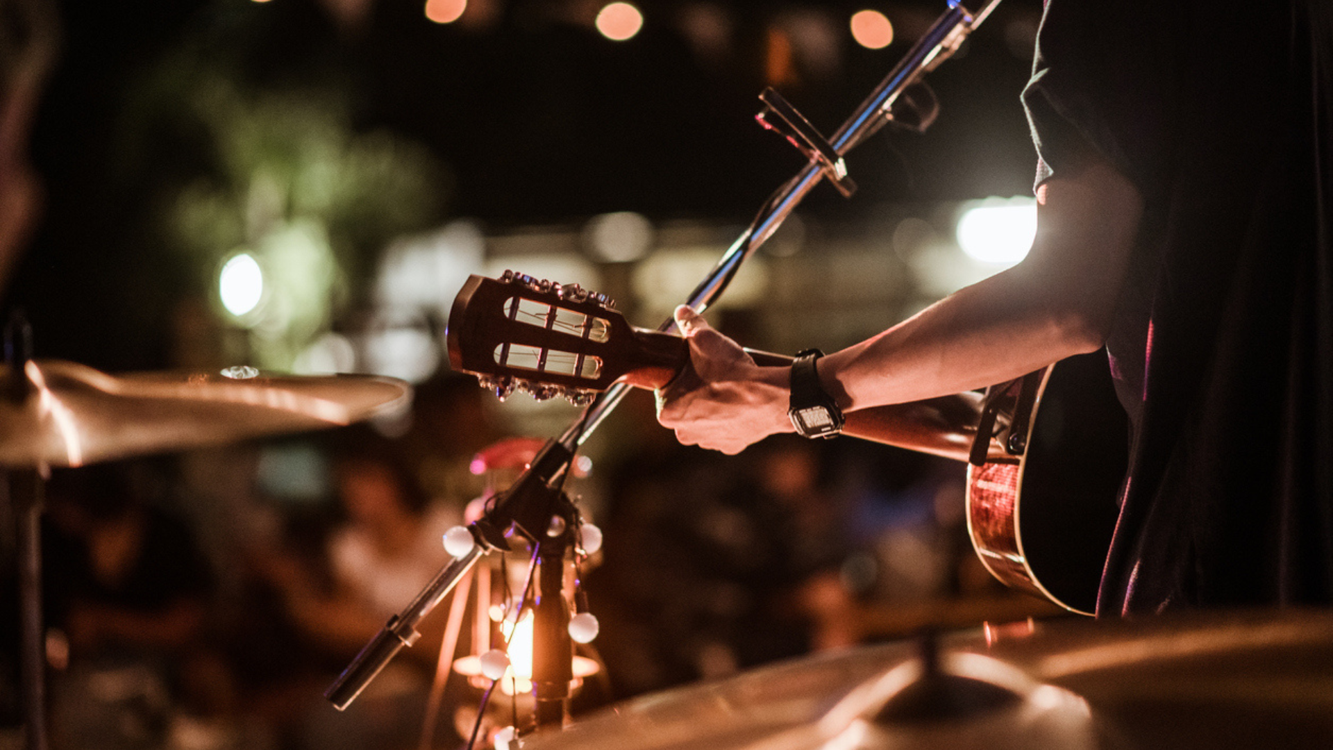 hand playing guitar with lights and drum hat
