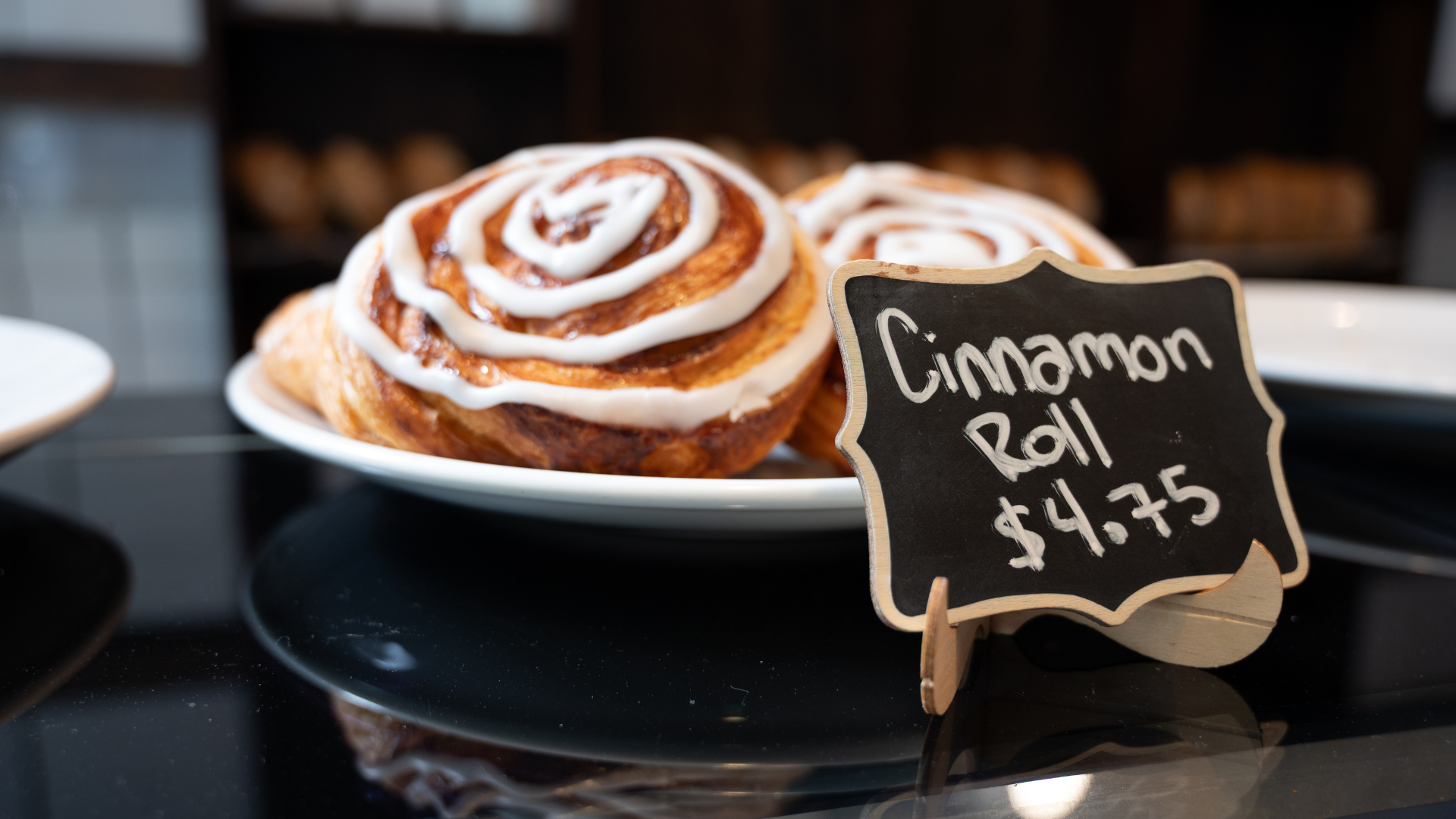 close up of bakery pastry with chalk board sign