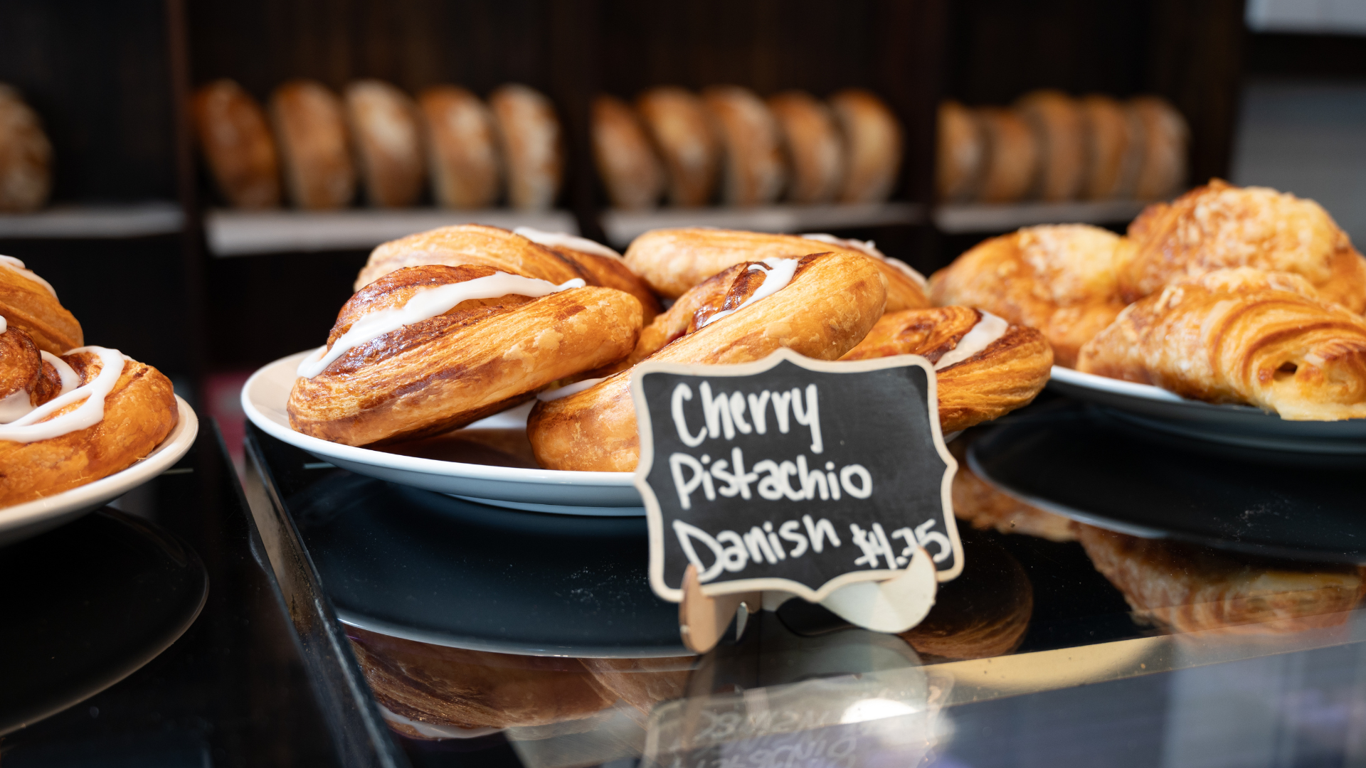 close up of bakery pastry with chalk board sign
