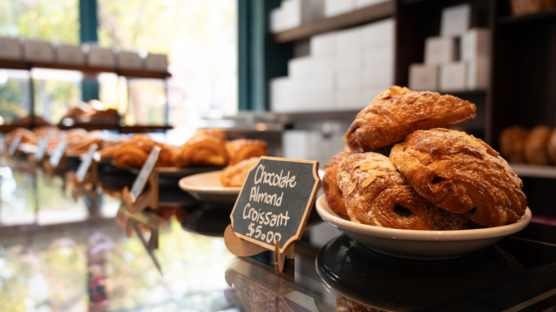 close up of bakery pastry with chalk board sign
