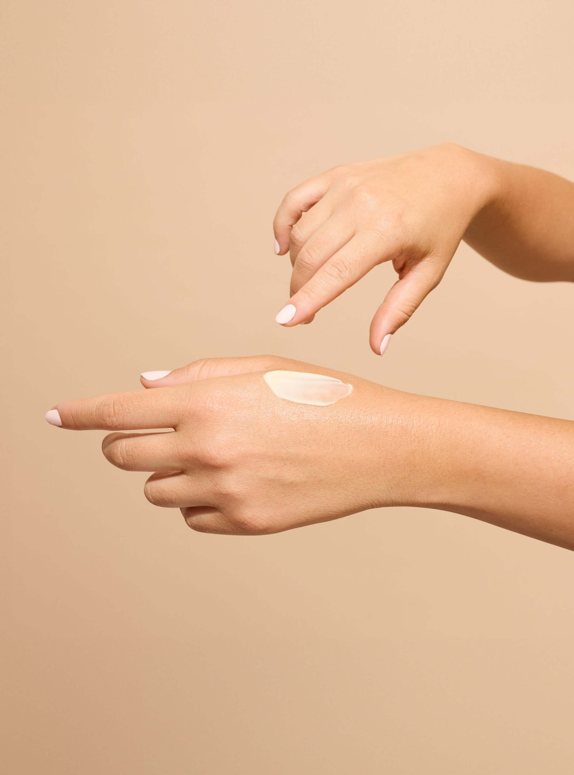 hands putting on product