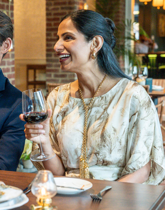 man and woman at a table, with plates of food and glasses