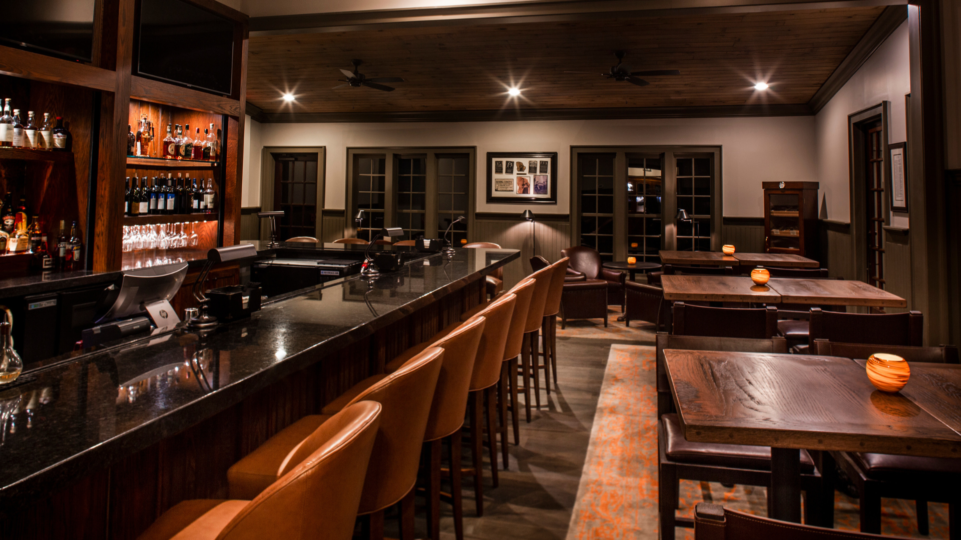 a dimly-lit bar with tables and chairs
