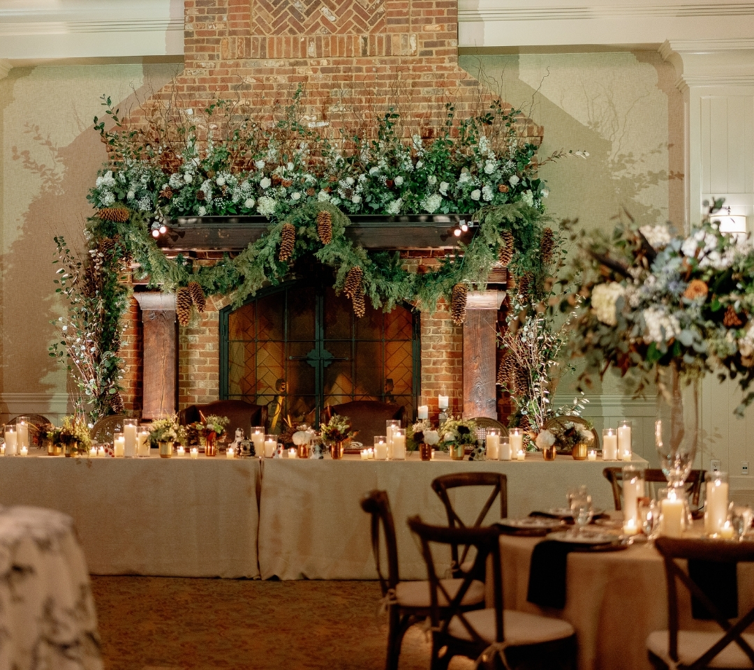 wedding setup with decor on tables and fireplace mantel
