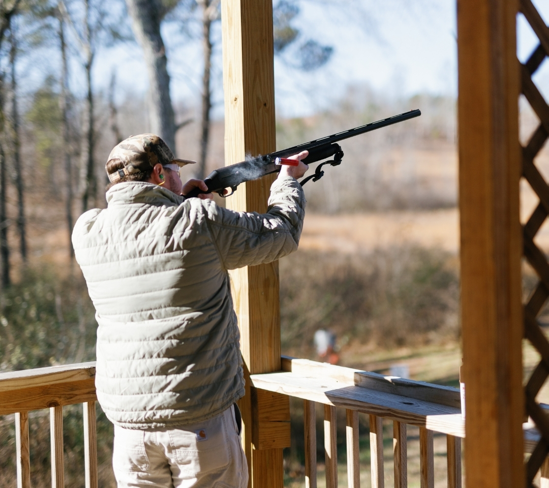 man shooting a gun at a range