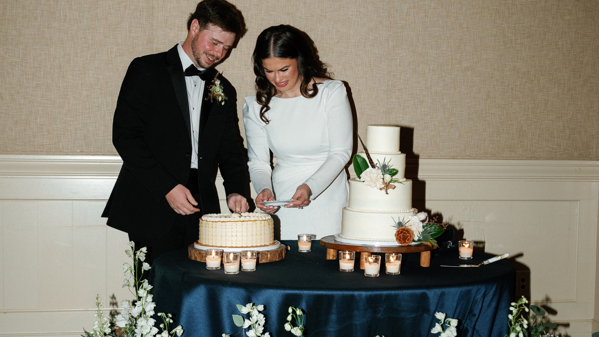 people cutting wedding cake