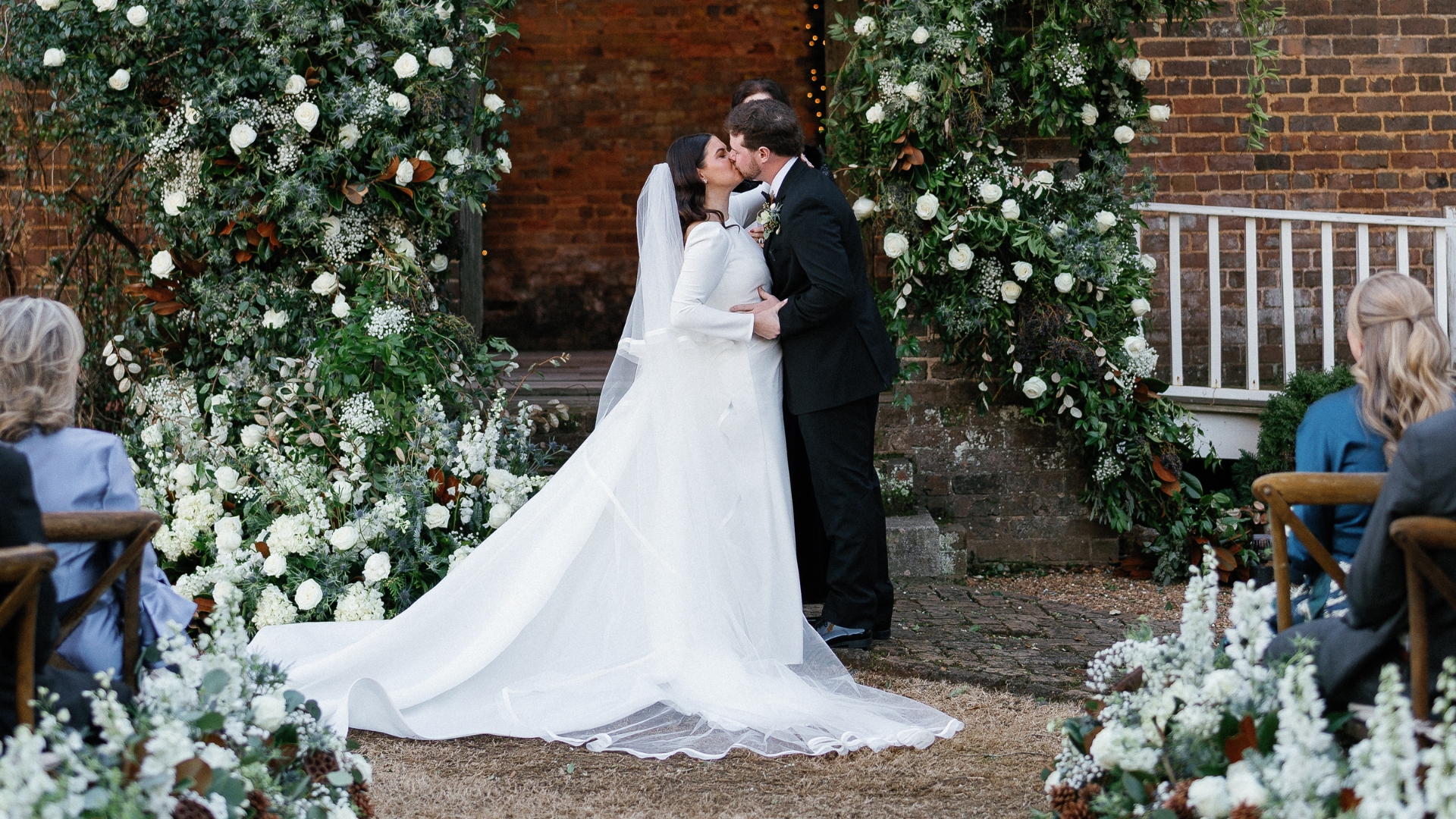 married couple kissing at alter