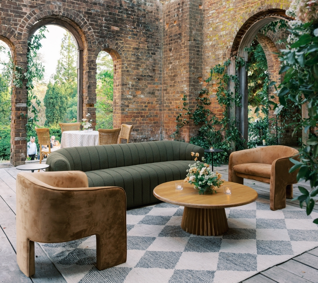 brick building with couch and chairs in the middle