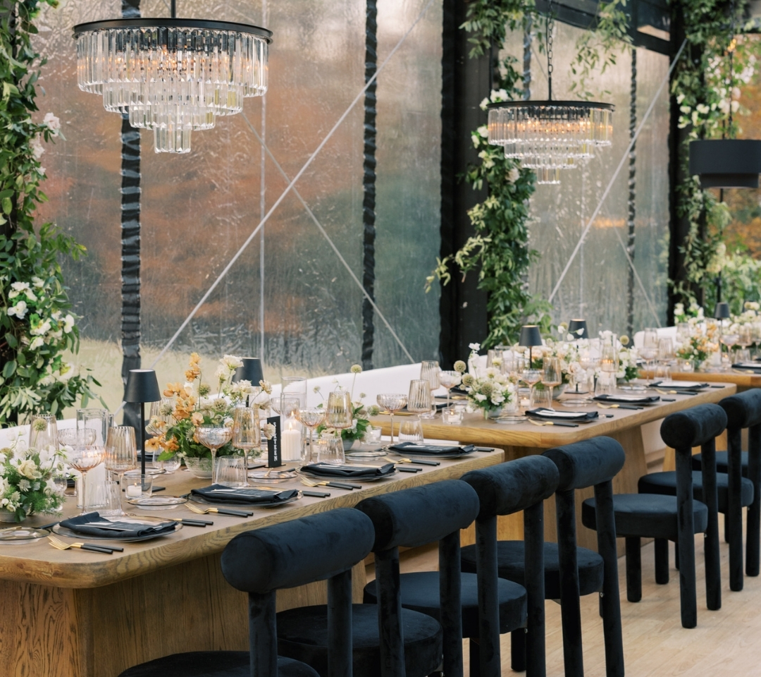black glass tent with wedding seating and decor