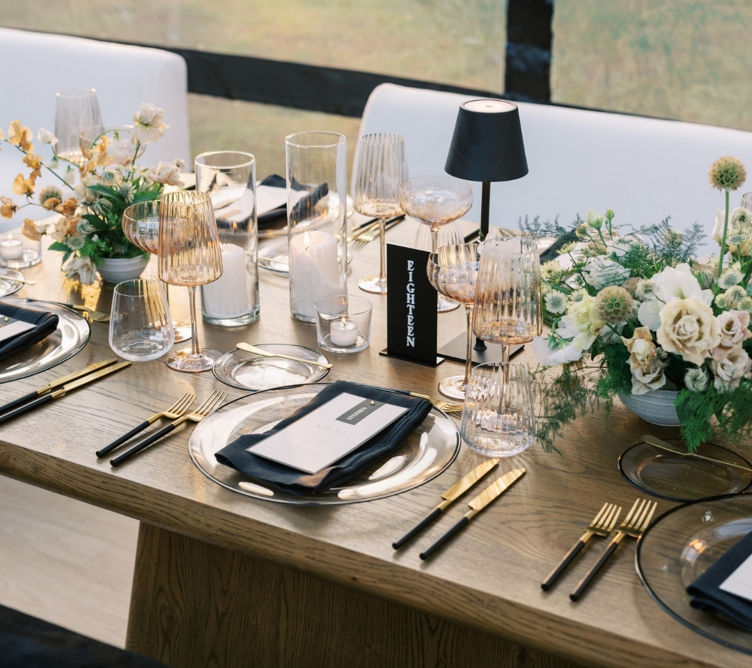 black glass tent with wedding seating and decor