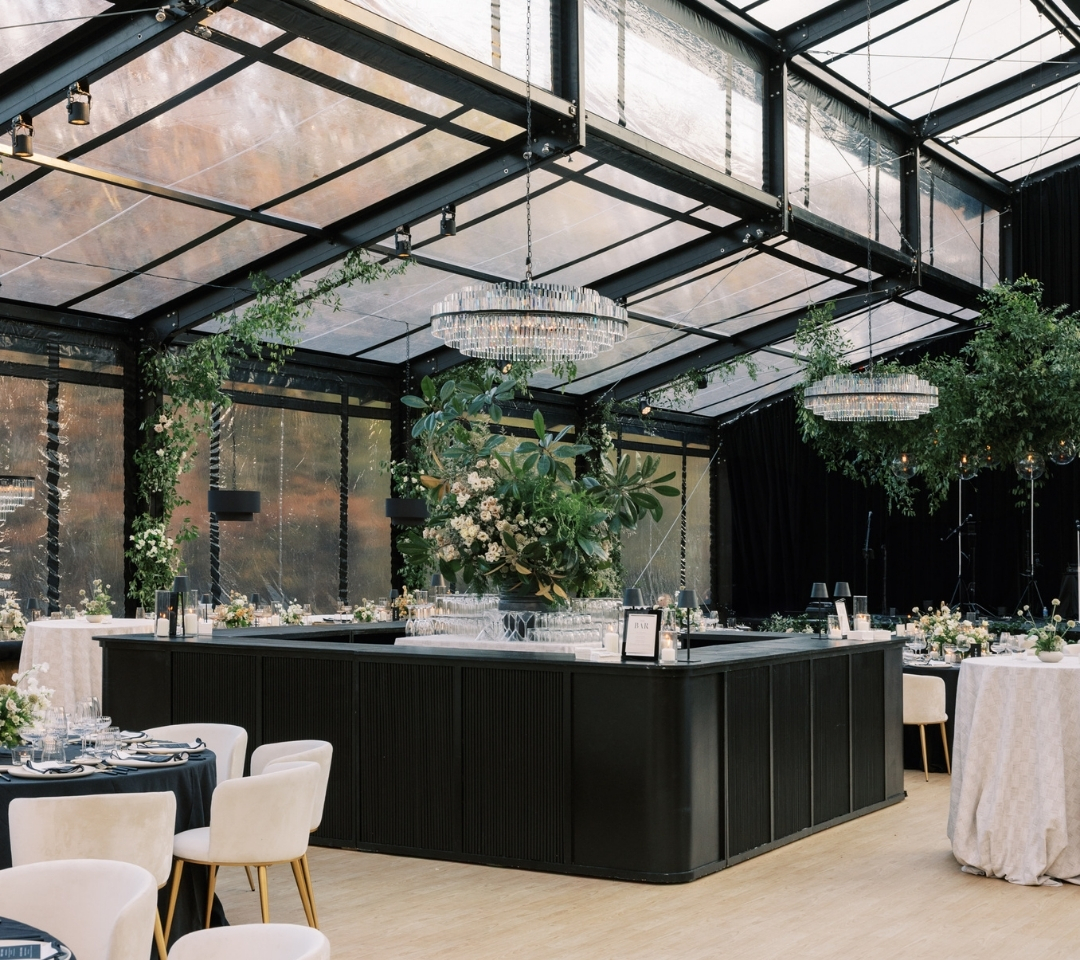 black glass tent with wedding seating and decor