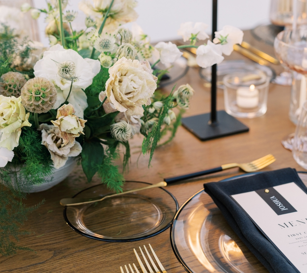 black glass tent with wedding seating and decor