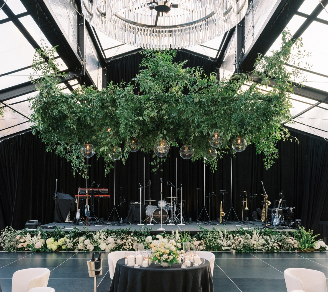black glass tent with wedding seating and decor