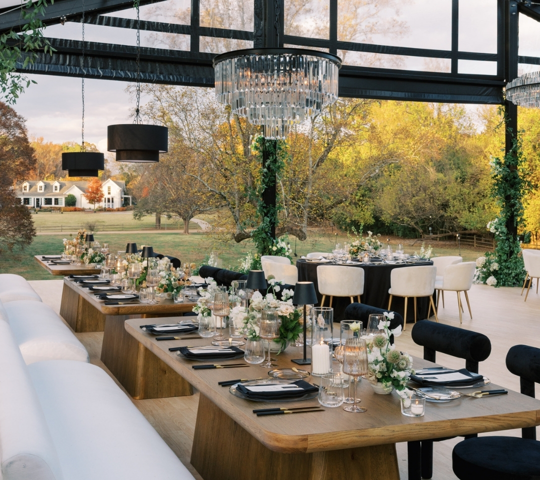 black glass tent with wedding seating and decor