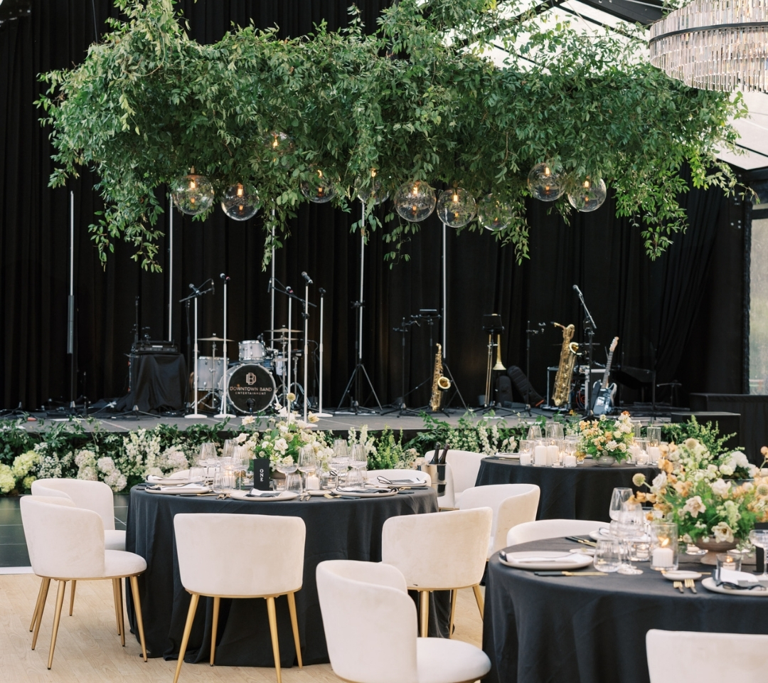 black glass tent with wedding seating and decor