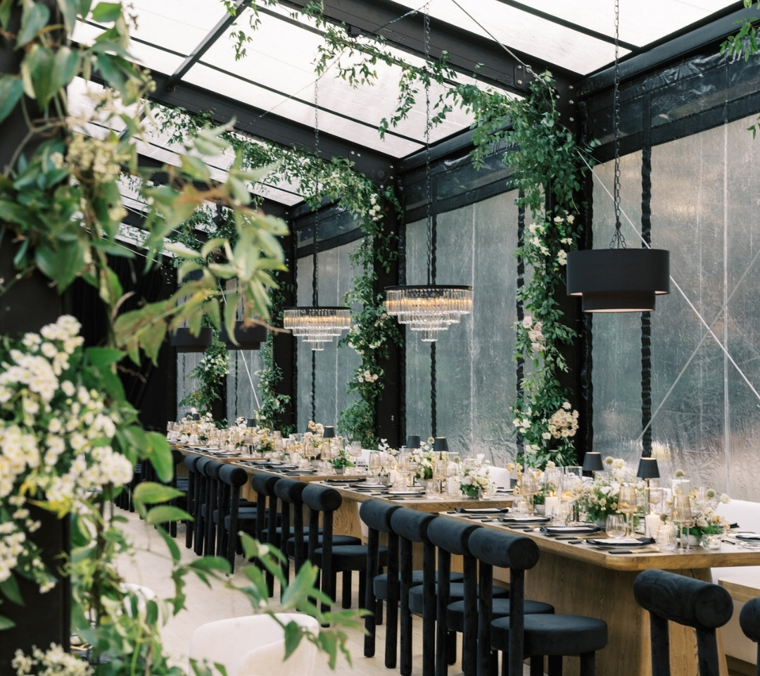 black glass tent with wedding seating and decor