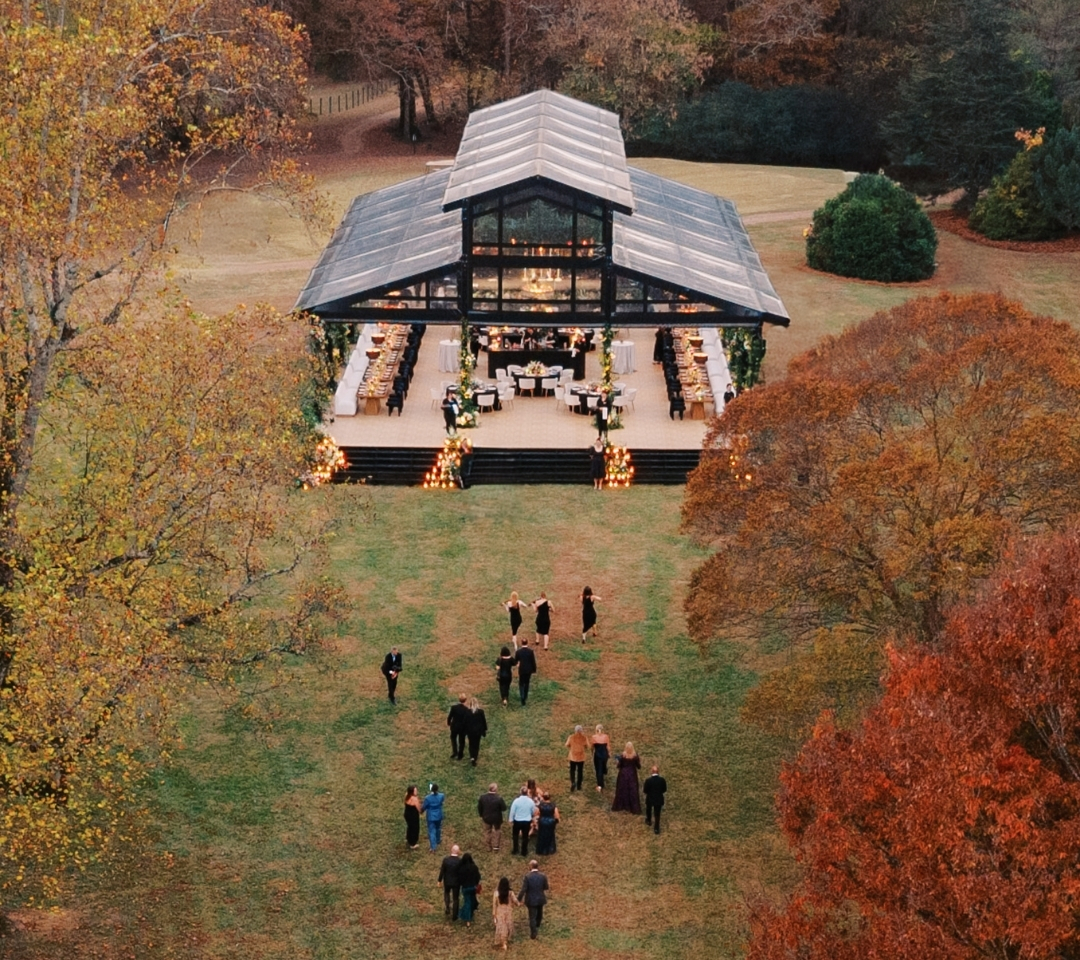 a large black glass tent in a field