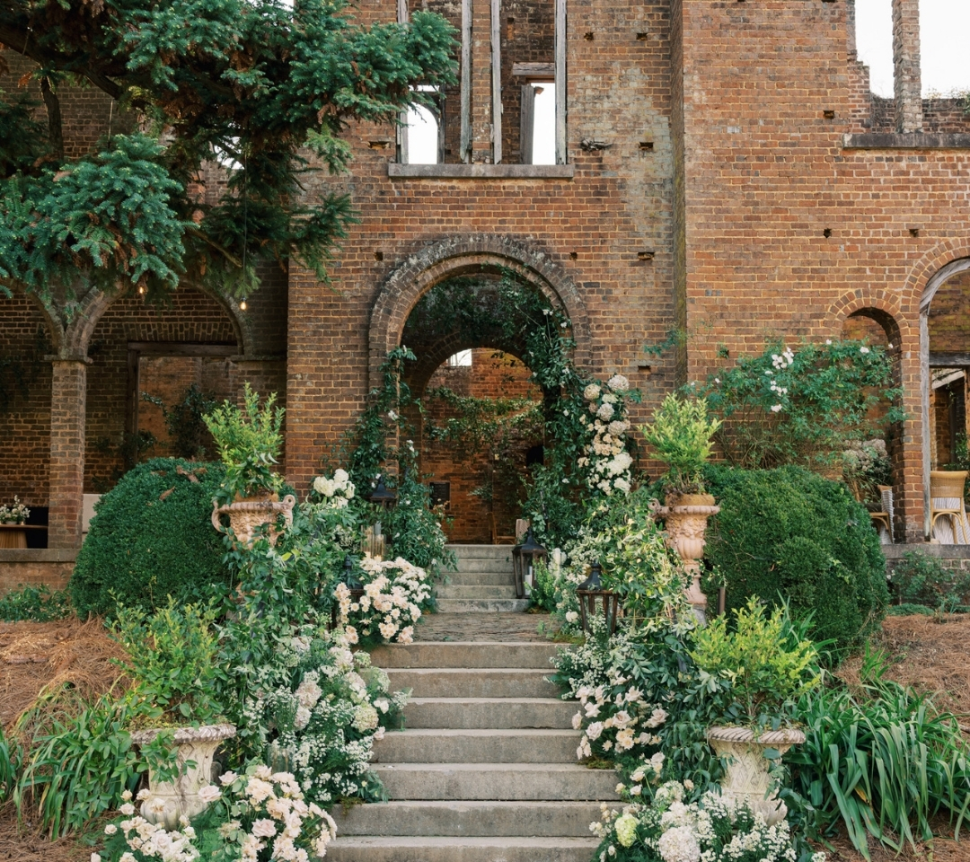 brick building with floral lined stairs
