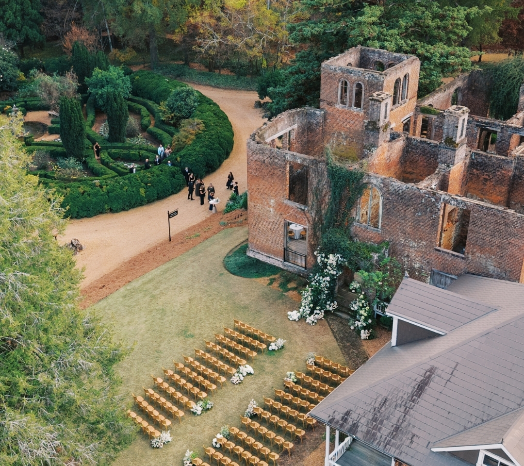 aerial of brick building with chairs lined in lawn